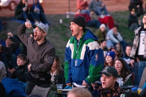 A man cheers for a basketball game 