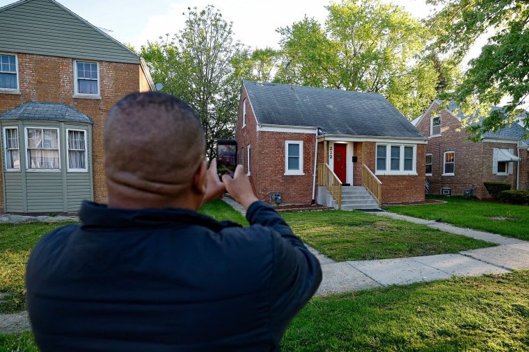 A person takes a photo of Pope Leo XIV's childhood home.