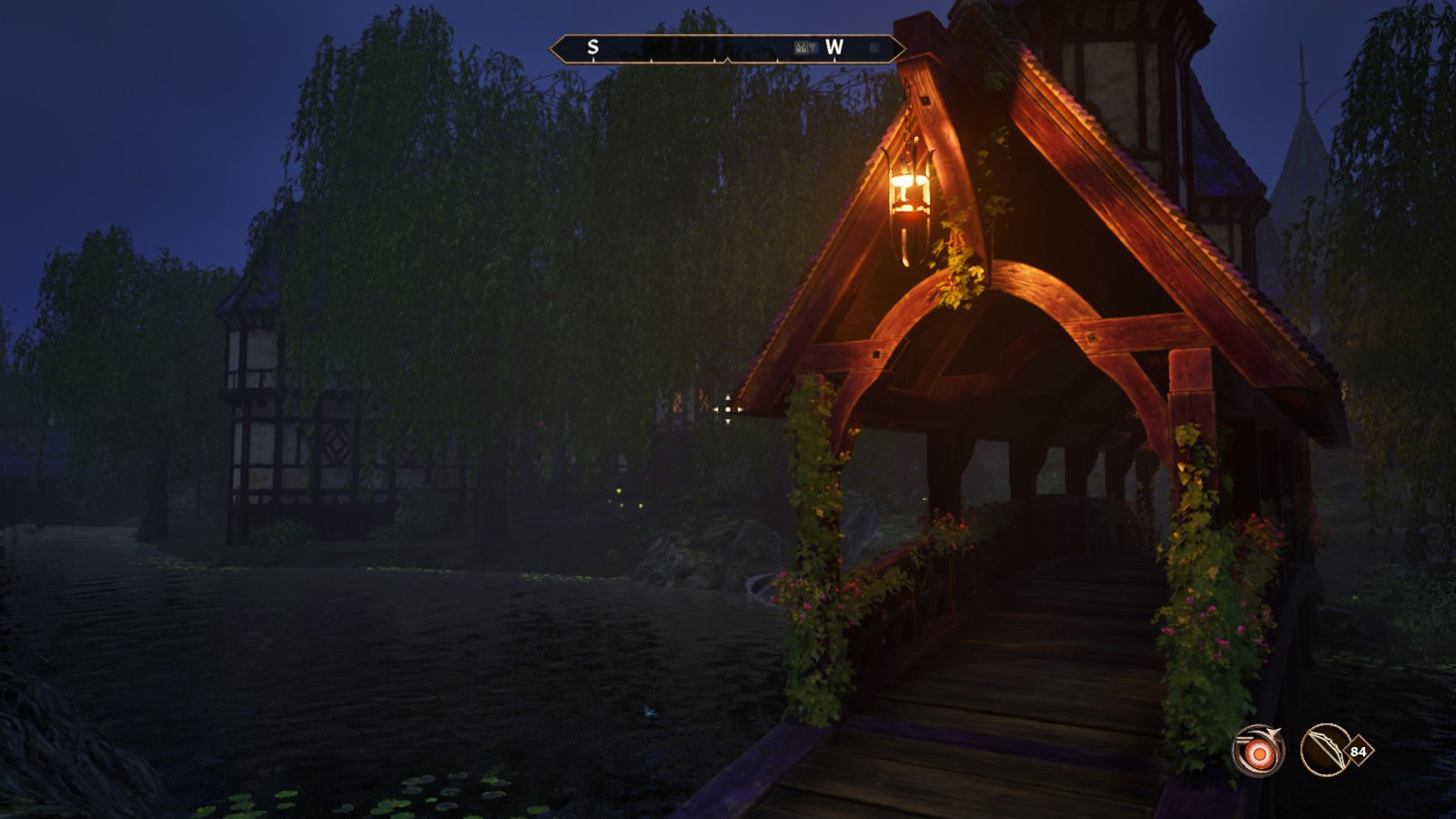 An image of Cheydinhal at night. A charming covered bridge with a lantern hanging from its roof sits over a moat.