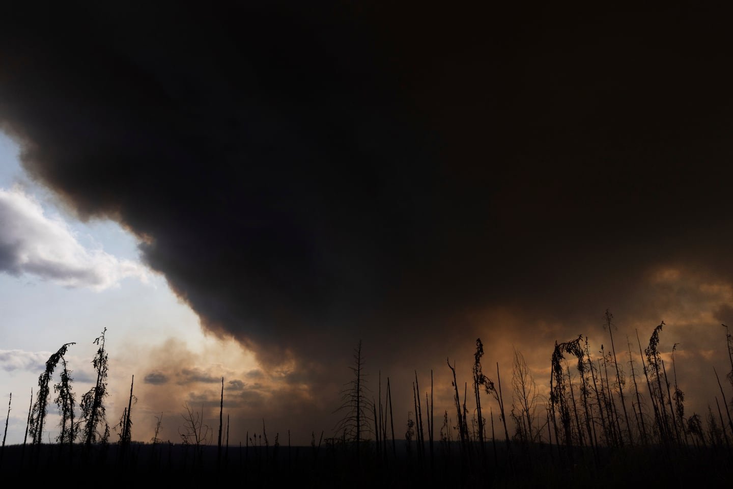 Wildfire smoke spewed into the air above Highway 97 north of Buckinghorse River, British Columbia, May 30.