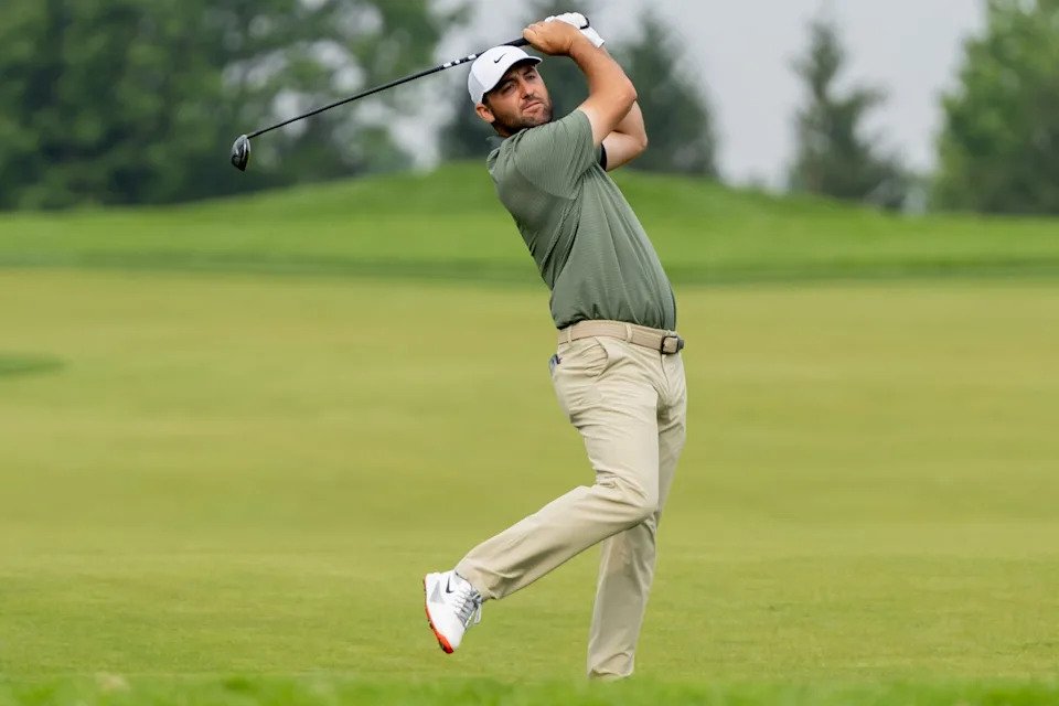 Scottie Scheffler lifts his leg up after hitting his second shot on the No. 12 fairway during the second round of the 125th U.S. Open at Oakmont Country Club in Oakmont, Pa. on June 13, 2025.
