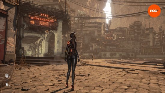 Stellar Blade PC review: A woman with black hair wearing a black jumpsuit, seen from behind, standing in a courtyard with neon signs, Eve from Stellar Blade.